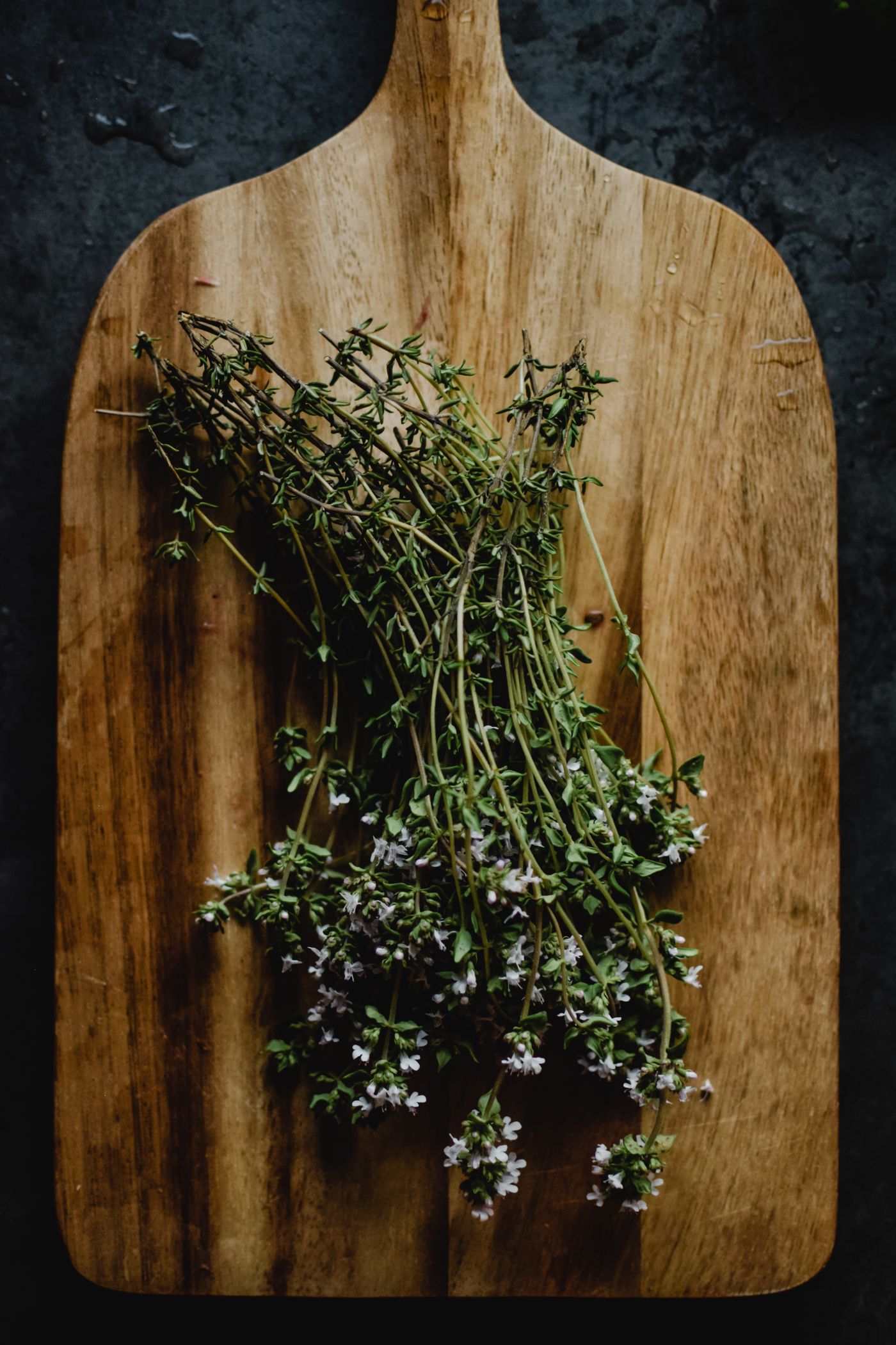 Fresh thyme arranged on a wooden board